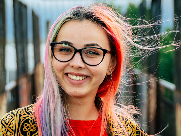 Young woman with colourful hair and glasses